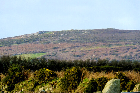 Chapel Carn Brea from Trevorgans menhir near St Buryan. The cairn on the right is the bronze age chambered summit cairn, and on the left is a neolithic longbarrow.